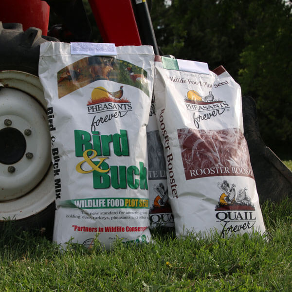 Bags of seed outside next to wheel of field equipment